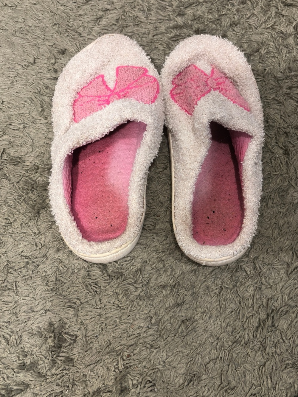 Heavily worn white fuzzy slippers